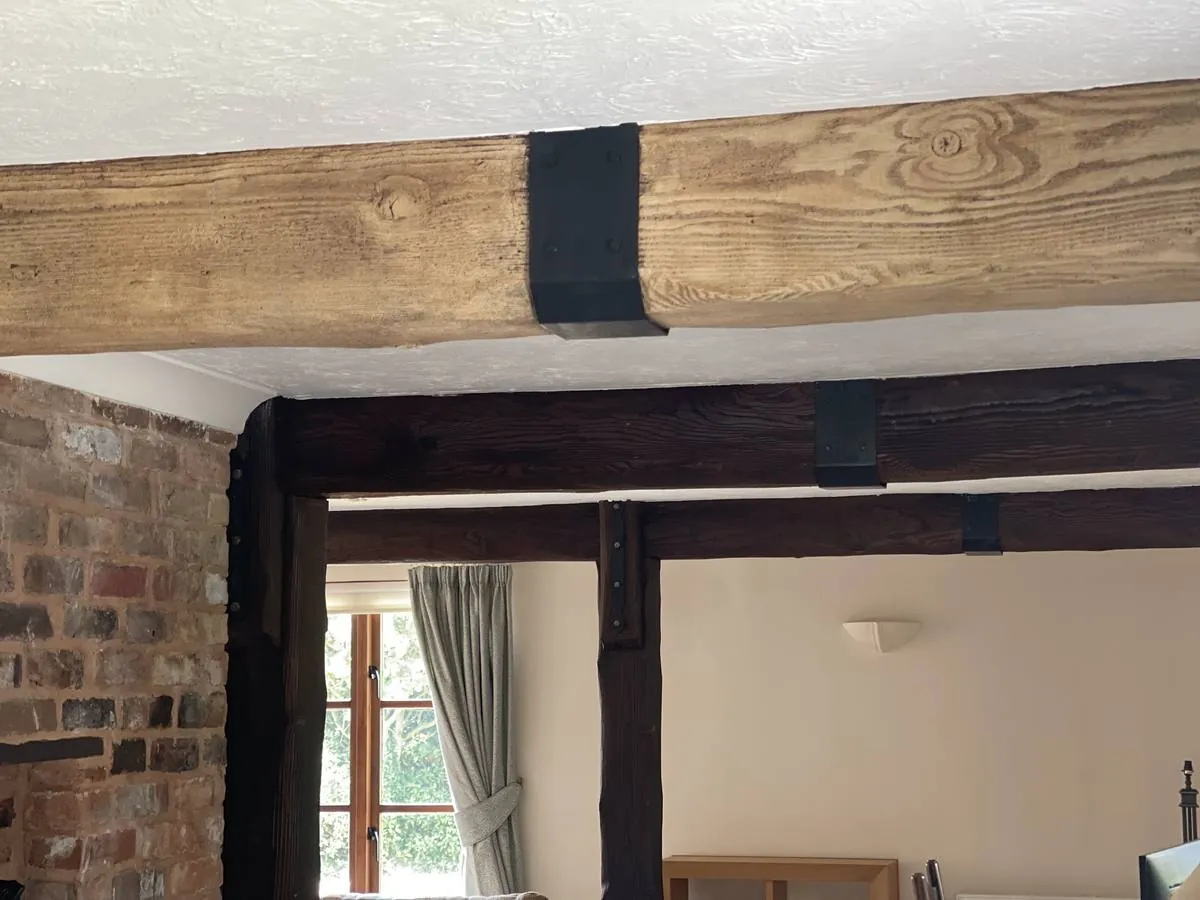 Dark-stained beams restored to natural timber in a Potton Gransden self-build in Bedfordshire